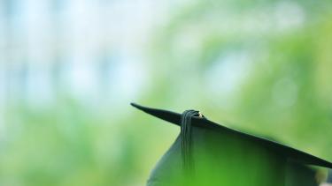 Detail view of graduation caps during commencement.