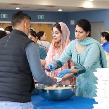 Adults receiving their lunch from the ATS PAC